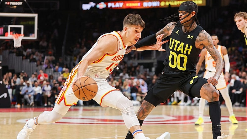Feb 27, 2024; Atlanta, Georgia, USA; Atlanta Hawks guard Bogdan Bogdanovic (13) drives on Utah Jazz guard Jordan Clarkson (00) in the second quarter at State Farm Arena. Mandatory Credit: Brett Davis-USA TODAY Sports