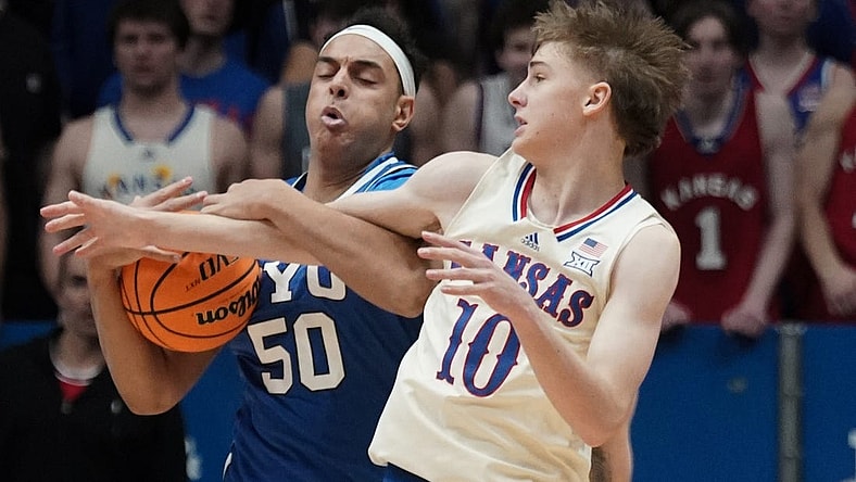 Feb 27, 2024; Lawrence, Kansas, USA; Brigham Young Cougars center Aly Khalifa (50) and Kansas Jayhawks guard Johnny Furphy (10) fight for a loose ball during the first half at Allen Fieldhouse. Mandatory Credit: Denny Medley-USA TODAY Sports