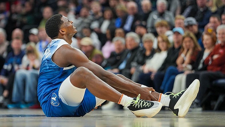 Feb 27, 2024; Minneapolis, Minnesota, USA; Minnesota Timberwolves guard Anthony Edwards (5) holds his ankle on the ground against the San Antonio Spurs in the second quarter at Target Center. Mandatory Credit: Brad Rempel-USA TODAY Sports