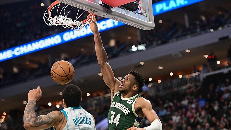 Feb 27, 2024; Milwaukee, Wisconsin, USA; Milwaukee Bucks forward Giannis Antetokounmpo (34) dunks the ball against Charlotte Hornets forward Miles Bridges (0) in the third quarter at Fiserv Forum. Mandatory Credit: Benny Sieu-USA TODAY Sports