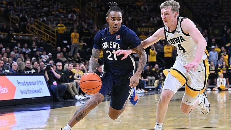 Feb 27, 2024; Iowa City, Iowa, USA; Penn State Nittany Lions guard RayQuawndis Mitchell (21) controls the ball as Iowa Hawkeyes guard Josh Dix (4) defends during the first half at Carver-Hawkeye Arena. Mandatory Credit: Jeffrey Becker-USA TODAY Sports