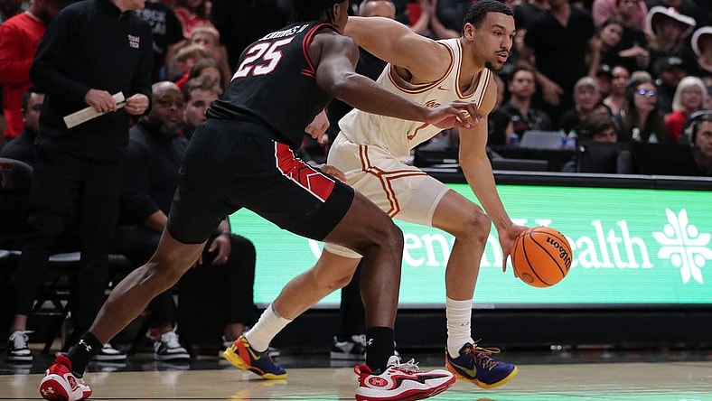Feb 27, 2024; Lubbock, Texas, USA;  UT Longhorns forward Dylan Disu (1) dribbles the ball against Texas Tech Red Raiders forward Robert Jennings (25) in the first half  at United Supermarkets Arena. Mandatory Credit: Michael C. Johnson-USA TODAY Sports