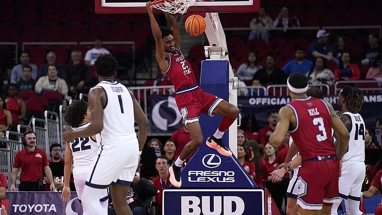 Feb 27, 2024; Fresno, California, USA; Fresno State Bulldogs guard Leo Colimerio (23) dunks the ball against the Utah State Aggies in the first half at the Save Mart Center. Mandatory Credit: Cary Edmondson-USA TODAY Sports