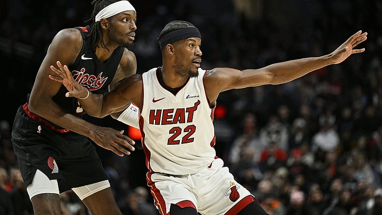 Feb 27, 2024; Portland, Oregon, USA; Miami Heat forward Jimmy Butler (22) reaches for a pass during the second half against Portland Trail Blazers forward Jerami Grant (9) at Moda Center. Mandatory Credit: Troy Wayrynen-USA TODAY Sports