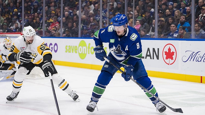 Feb 27, 2024; Vancouver, British Columbia, CAN; Pittsburgh Penguins defenseman Erik Karlsson (65) defends against Vancouver Canucks forward J.T. Miller (9) in the third period at Rogers Arena. Penguins won 4-3 in overtime. Mandatory Credit: Bob Frid-USA TODAY Sports