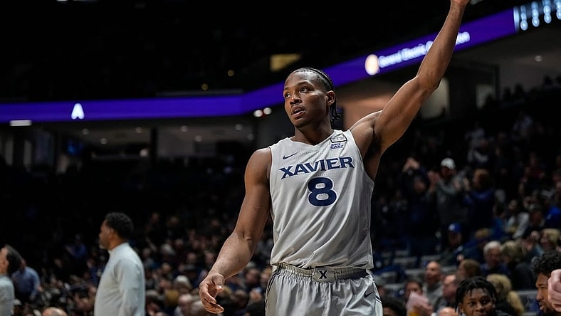 Xavier Musketeers guard Quincy Olivari (8) waves to the crowd as they applaud his 2001st career point scored in the first half of the NCAA Big East conference basketball game between the Xavier Musketeers and the DePaul Blue Demons at the Cintas Center in Cincinnati on Wednesday, Feb. 28, 2024.