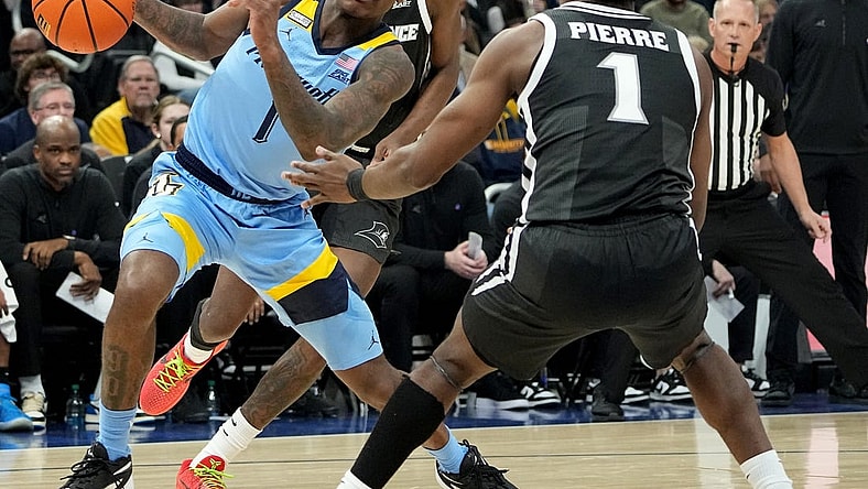 Feb 28, 2024; Milwaukee, Wisconsin, USA; Marquette guard Kam Jones (1) makes a move on Providence guard Jayden Pierre (1) during the first half of their game at Fiserv Forum. Mandatory Credit: Mark Hoffman/Milwaukee Journal Sentinel-USA TODAY Sports