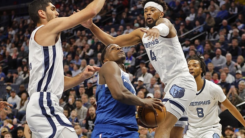 Feb 28, 2024; Minneapolis, Minnesota, USA; Minnesota Timberwolves guard Anthony Edwards (5) goes to the basket between Memphis Grizzlies forward Santi Aldama (7) and guard Jordan Goodwin (4) in the first quarter at Target Center. Mandatory Credit: Bruce Kluckhohn-USA TODAY Sports