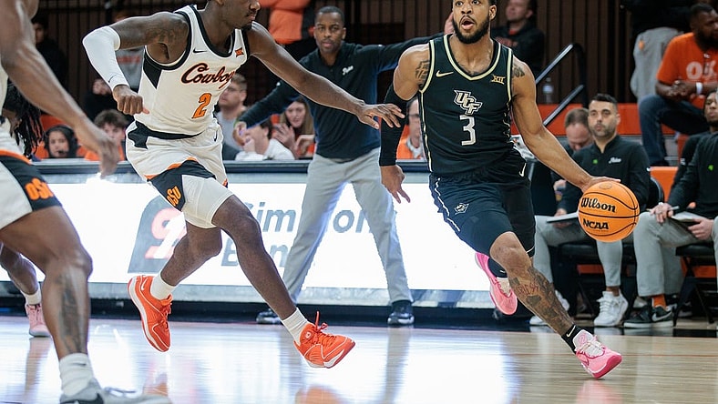 Feb 28, 2024; Stillwater, Oklahoma, USA; UCF Knights guard Darius Johnson (3) drives to the basket around Oklahoma State Cowboys forward Eric Dailey Jr. (2) during the first half at Gallagher-Iba Arena. Mandatory Credit: William Purnell-USA TODAY Sports