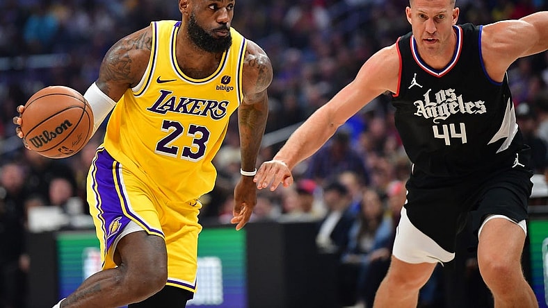 Feb 28, 2024; Los Angeles, California, USA; Los Angeles Lakers forward LeBron James (23) moves the ball against Los Angeles Clippers center Mason Plumlee (44) during the first half at Crypto.com Arena. Mandatory Credit: Gary A. Vasquez-USA TODAY Sports