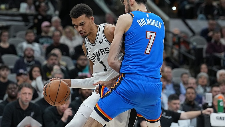 Feb 29, 2024; San Antonio, Texas, USA;  San Antonio Spurs center Victor Wembanyama (1) drives in against Oklahoma City Thunder forward Chet Holmgren (7) in the first half at Frost Bank Center. Mandatory Credit: Daniel Dunn-USA TODAY Sports