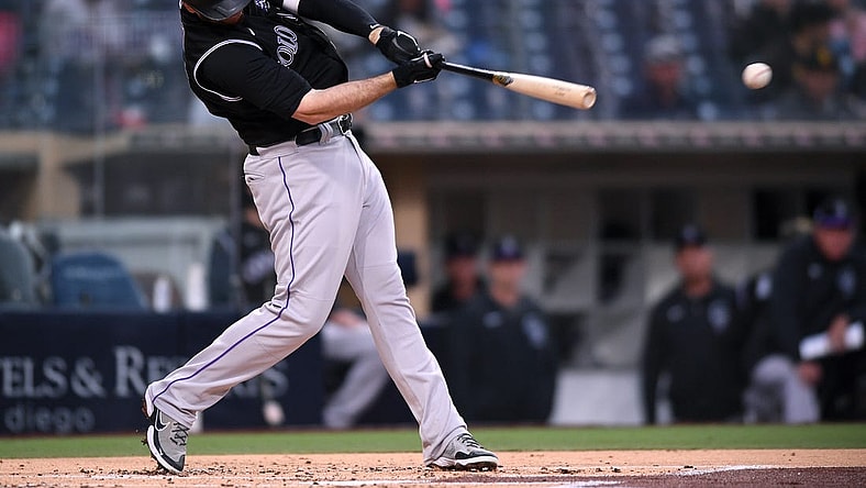 May 18, 2021; San Diego, California, USA; Colorado Rockies first baseman CJ Cron (25) singles against the San Diego Padres during the second inning at Petco Park. Mandatory Credit: Orlando Ramirez-USA TODAY Sports