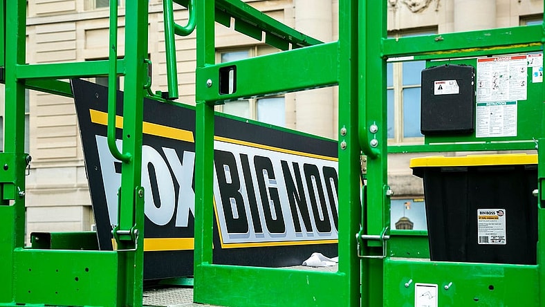 A Big Noon Kickoff logo is seen on a lift as setup continues for the Fox Sports NCAA football Big Noon Kickoff pregame show, Friday, Oct. 8, 2021, on the east side of the Pentacrest on the University of Iowa campus in Iowa City, Iowa.

211008 Big Noon Setup 007 Jpg