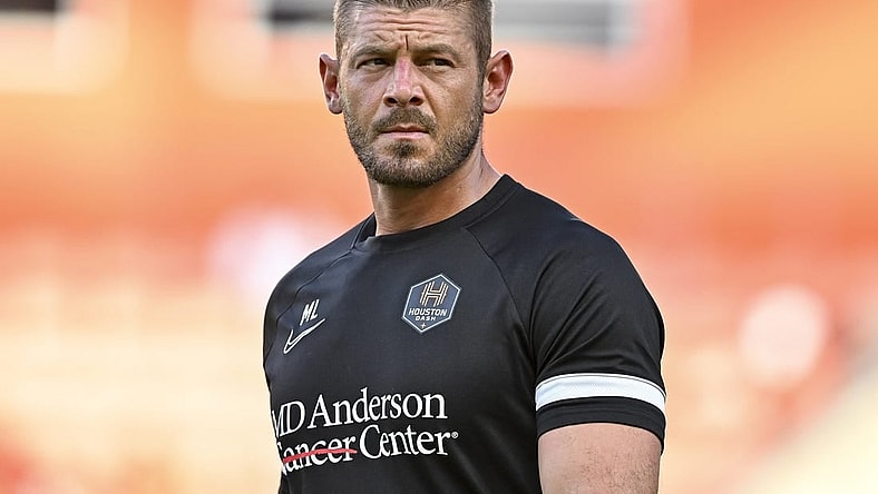 Jun 12, 2022; Houston, Texas, USA; Houston Dash goalkeeper coach Matt Lampson enters the pitch prior to the start of the second half against the Portland Thorns FC in a NWSL match at PNC Stadium. Mandatory Credit: Maria Lysaker-USA TODAY Sports