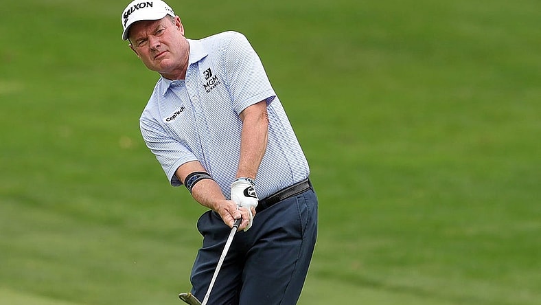 Joe Durant chips onto the green on the 4th hole during second round of the Bridgestone Senior Players Tournament at Firestone Country Club on Friday.

Bridgestonejl 10