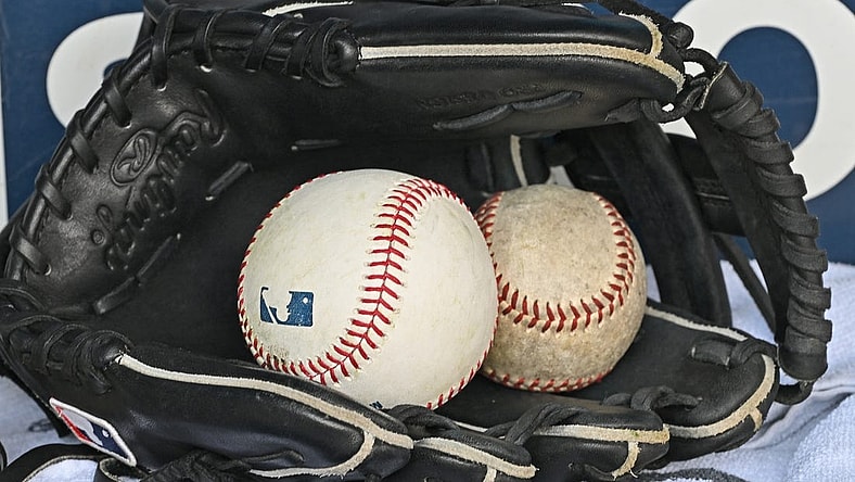 Aug 14, 2022; Kansas City, Missouri, USA;  A general view of a baseball glove and baseballs prior to a game between the Kansas City Royals and Los Angeles Dodgers at Kauffman Stadium. Mandatory Credit: Peter Aiken-USA TODAY Sports