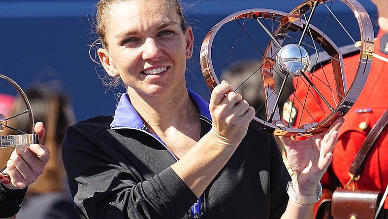 Aug 14, 2022; Toronto, ON, Canada; Simona Halep (ROU) poses with the National Bank Open trophy after defeating Beatriz Haddad Maia (not pictured)  in the women's final of the National Bank Open at Sobeys Stadium. Mandatory Credit: John E. Sokolowski-USA TODAY Sports