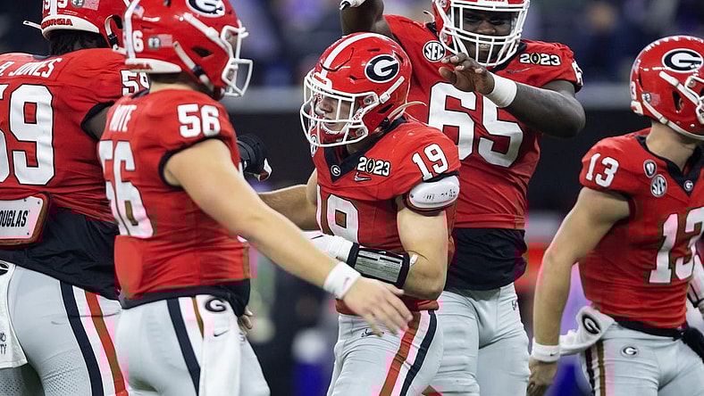 Georgia Bulldogs tight end Brock Bowers (19) celebrates a touchdown with offensive lineman Amarius Mims (65) against the TCU Horned Frogs during the CFP national championship game at SoFi Stadium. Mandatory Credit: Mark J. Rebilas-USA TODAY Sports