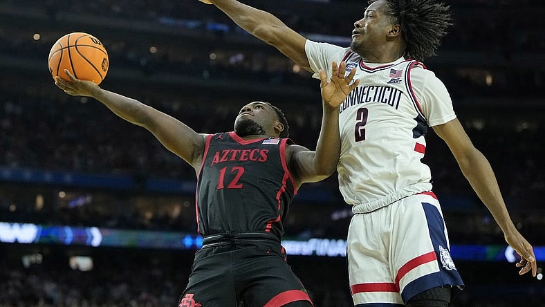 Apr 3, 2023; Houston, TX, USA; San Diego State Aztecs guard Darrion Trammell (12) shoots the ball against Connecticut Huskies guard Tristen Newton (2) during the second half in the national championship game of the 2023 NCAA Tournament at NRG Stadium. Mandatory Credit: Bob Donnan-USA TODAY Sports