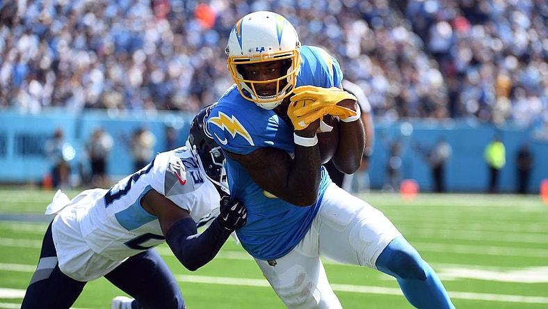 Sep 17, 2023; Nashville, Tennessee, USA; Los Angeles Chargers wide receiver Mike Williams (81) runs after a catch against Tennessee Titans cornerback Tre Avery (23) during the first half at Nissan Stadium. Mandatory Credit: Christopher Hanewinckel-USA TODAY Sports