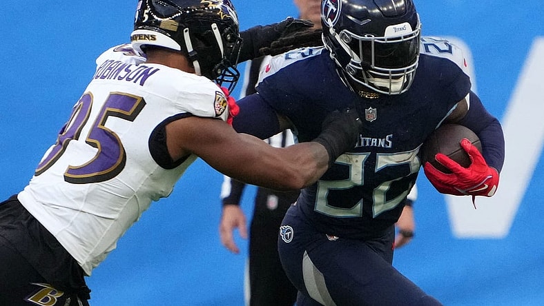 Oct 15, 2023; London, United Kingdom; Tennessee Titans running back Derrick Henry (22) carries the ball against Baltimore Ravens linebacker Tavius Robinson (95) in the second half during an NFL International Series game at Tottenham Hotspur Stadium. Mandatory Credit: Kirby Lee-USA TODAY Sports