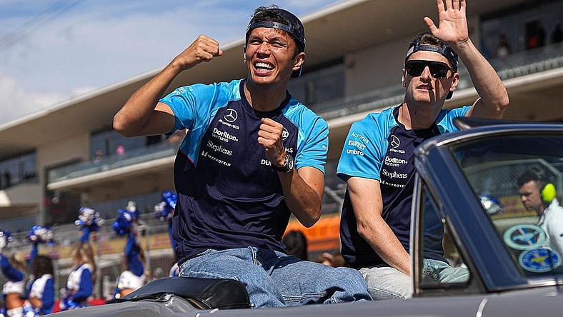 Williams Racing drivers Alex Albon, left, and Logan Sargeant, right wave to the crowd during the drivers parade ahead of the Formula 1 Lenovo United States Grand Prix at Circuit of Americas on Sunday Oct. 22, 2023.