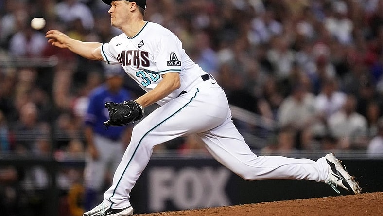 Arizona Diamondbacks relief pitcher Paul Sewald (38) pitches during the ninth inning during game five of the 2023 World Series at Chase Field.