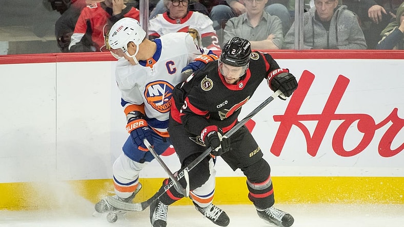 Nov 24 2023; Ottawa, Ontario, CAN; New York Islanders left wing Anders Lee (27) battles with Ottawa Senators defenseman Artem Zub (2) in the third period at the Canadian Tire Centre. Mandatory Credit: Marc DesRosiers-USA TODAY Sports