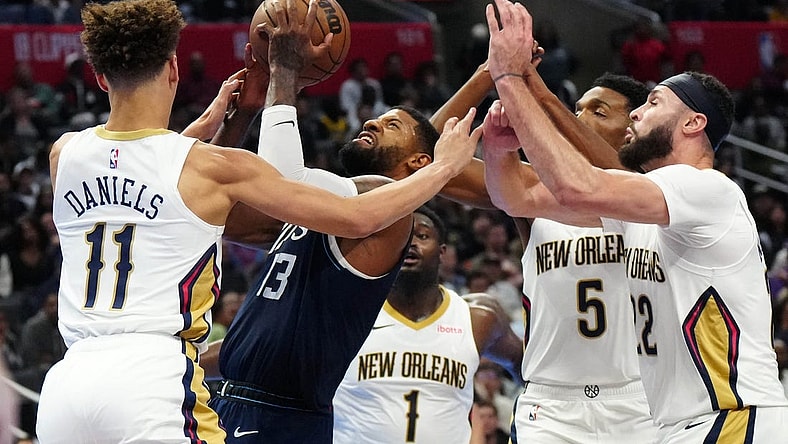 Nov 24, 2023; Los Angeles, California, USA; LA Clippers forward Paul George (13) shoots the ball against New Orleans Pelicans guard Dyson Daniels (11) and forwards Zion Williamson (1), Herbert Jones (5) and Larry Nance Jr. (22) in the second half at Crypto.com Arena. Mandatory Credit: Kirby Lee-USA TODAY Sports