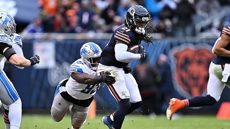 Dec 10, 2023; Chicago, Illinois, USA;  Detroit Lions defensive lineman Josh Paschal (93) hangs on to Chicago Bears running back D'Onta Foreman (21) to make the tackle in the second half at Soldier Field. Mandatory Credit: Jamie Sabau-USA TODAY Sports