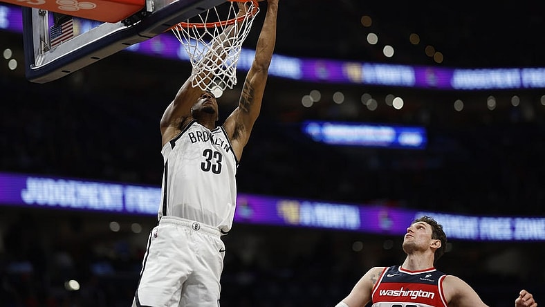 Dec 29, 2023; Washington, District of Columbia, USA; Brooklyn Nets center Nic Claxton (33) attempts to dunk the ball as Washington Wizards center Mike Muscala (35) looks on in the fourth quarter at Capital One Arena. Mandatory Credit: Geoff Burke-USA TODAY Sports