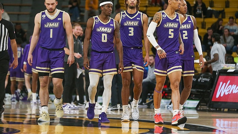 Jan 6, 2024; Hattiesburg, Mississippi, USA; James Madison Dukes players Noah Freidel (1), Xavier Brown (0), T.J. Bickerstaff (3), Terrence Edwards Jr. (5), and Raekwon Horton (2) after a timeout during the second half of their game against the Southern Miss Golden Eagles at Reed Green Coliseum. Mandatory Credit: Chuck Cook-USA TODAY Sports