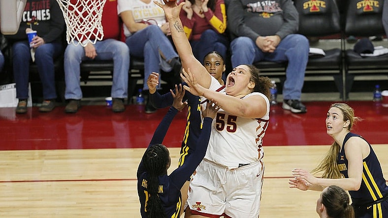 Iowa State Cyclones center Audi Crooks (55) takes a shot between West Virginia Mountaineers guard Jordan Harrison (10) and forward Kylee Blacksten (14) during the third quarter in the Big-12 conference matchup at Hilton Coliseum on Wednesday, Jan. 10, 2024, in Ames, Iowa.