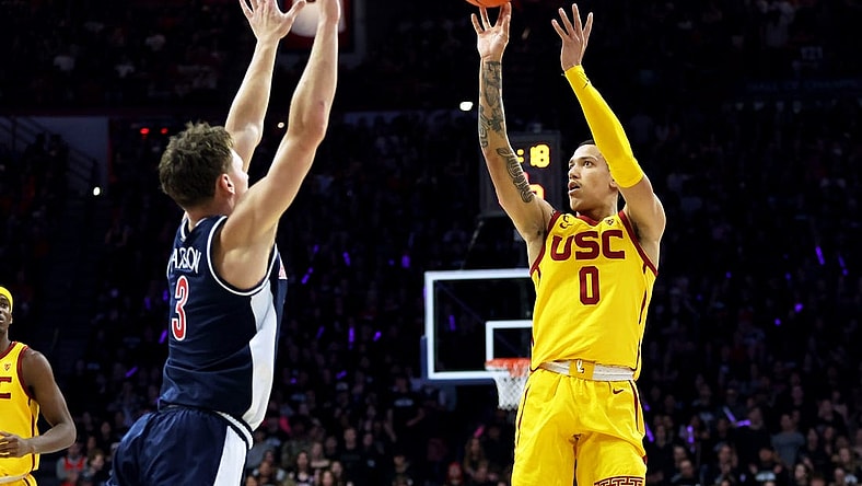 Jan 17, 2024; Tucson, Arizona, USA; USC Trojans guard Kobe Johnson (0) shoots a basket against Arizona Wildcats guard Pelle Larsson (3) during the first half at McKale Center. Mandatory Credit: Zachary BonDurant-USA TODAY Sports