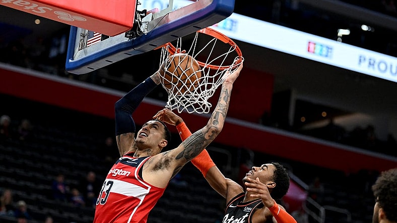 Jan 27, 2024; Detroit, Michigan, USA; Washington Wizards forward Kyle Kuzma (33) dunks the ball over Detroit Pistons guard Jaden Ivey (23) in the fourth quarter at Little Caesars Arena. Mandatory Credit: Lon Horwedel-USA TODAY Sports