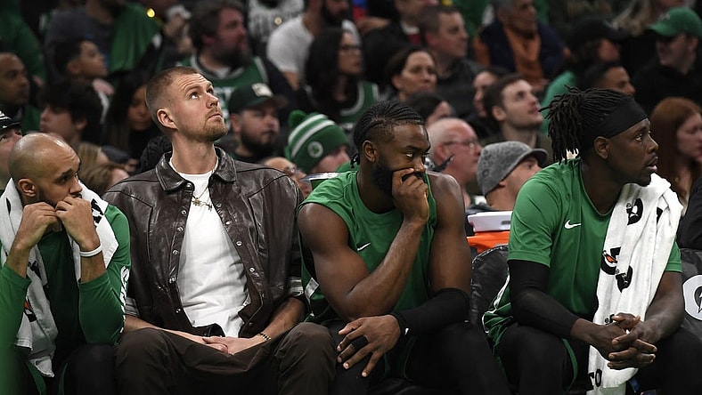 Jan 27, 2024; Boston, Massachusetts, USA;  Boston Celtics center Kristaps Porzingis (8) guard Jaylen Brown (7) and guard Jrue Holiday (4) on the bench during the second half against the LA Clippers at TD Garden. Mandatory Credit: Bob DeChiara-USA TODAY Sports
