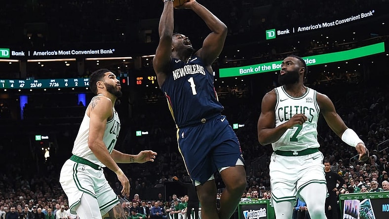 Jan 29, 2024; Boston, Massachusetts, USA;  New Orleans Pelicans forward Zion Williamson (1) shoots the ball between Boston Celtics forward Jayson Tatum (0) and guard Jaylen Brown (7) during the second half at TD Garden. Mandatory Credit: Bob DeChiara-USA TODAY Sports