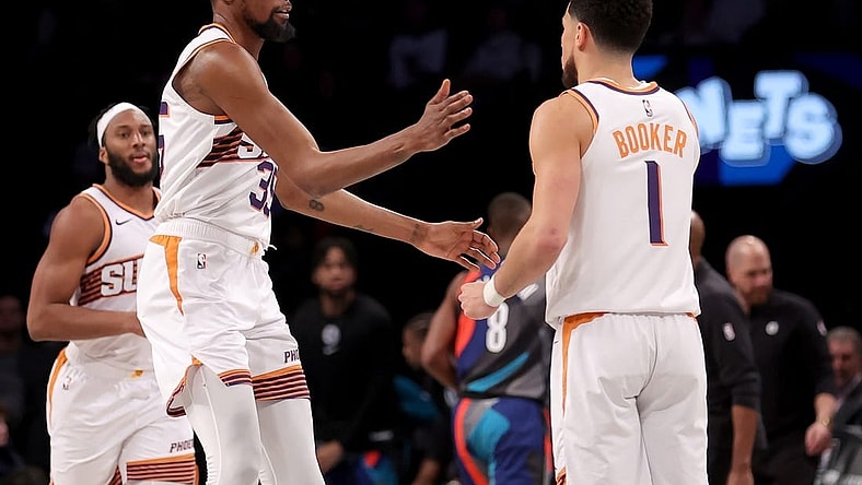 Jan 31, 2024; Brooklyn, New York, USA; Phoenix Suns forward Kevin Durant (35) high fives guard Devin Booker (1) during the third quarter against the Brooklyn Nets at Barclays Center. Mandatory Credit: Brad Penner-USA TODAY Sports