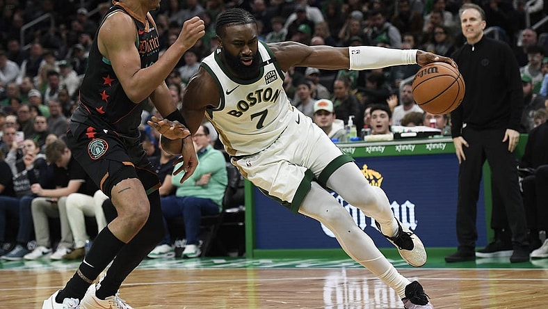 Feb 9, 2024; Boston, Massachusetts, USA; Boston Celtics guard Jaylen Brown (7) controls the ball while Washington Wizards guard Jordan Poole (13) defends during the second half at TD Garden. Mandatory Credit: Bob DeChiara-USA TODAY Sports