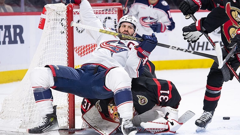 Feb 13, 2024; Ottawa, Ontario, CAN; Columbus Blue Jackets center Boone Jenner (38) falls on top of Ottawa Senators goalie Anton Forsberg (31)in a battle in the second period at the Canadian Tire Centre. Mandatory Credit: Marc DesRosiers-USA TODAY Sports