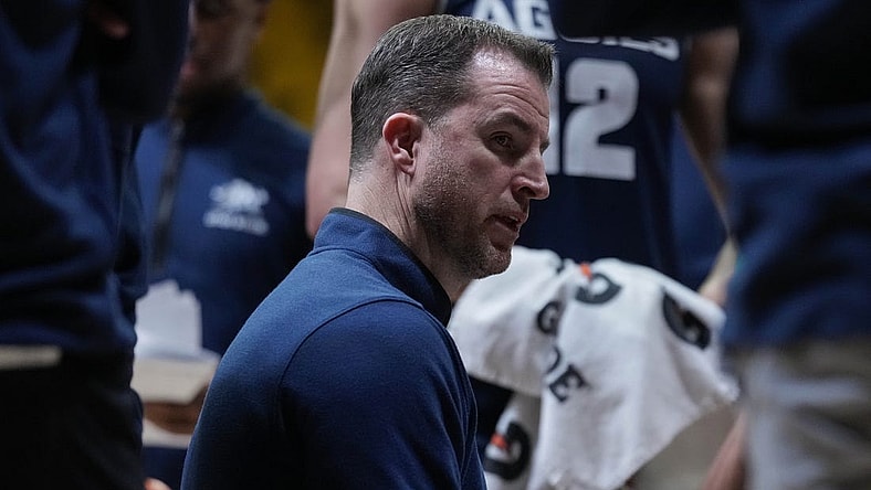Feb 14, 2024; Laramie, Wyoming, USA; Utah State Aggies head coach Danny Sprinkle draws up a play against the Wyoming Cowboys during the second half at Arena-Auditorium. Mandatory Credit: Troy Babbitt-USA TODAY Sports