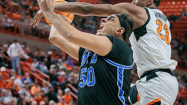 Feb 17, 2024; Stillwater, Oklahoma, USA; Oklahoma State Cowboys center Brandon Garrison (23) gets tangled up with Brigham Young Cougars center Aly Khalifa (50) during the second half at Gallagher-Iba Arena. Mandatory Credit: William Purnell-USA TODAY Sports