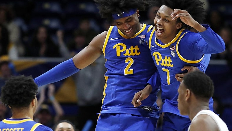 Feb 17, 2024; Pittsburgh, Pennsylvania, USA;  Pittsburgh Panthers forward Blake Hinson (2) and guard Carlton Carrington (7) celebrate after Hinson hit a three point basket to break the forty point mark against the Louisville Cardinals during the second half at the Petersen Events Center. Pittsburgh won 86-59. Mandatory Credit: Charles LeClaire-USA TODAY Sports