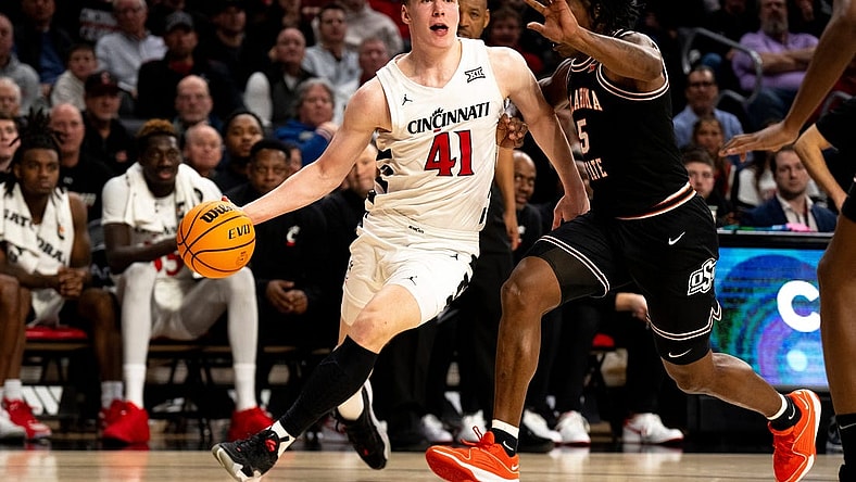 Cincinnati Bearcats guard Simas Lukosius (41) drives on Oklahoma State Cowboys guard Quion Williams (5) in the second half of the NCAA basketball game between Cincinnati Bearcats and Oklahoma State Cowboys at Fifth Third Arena in Cincinnati on Wednesday, Feb. 21, 2024.