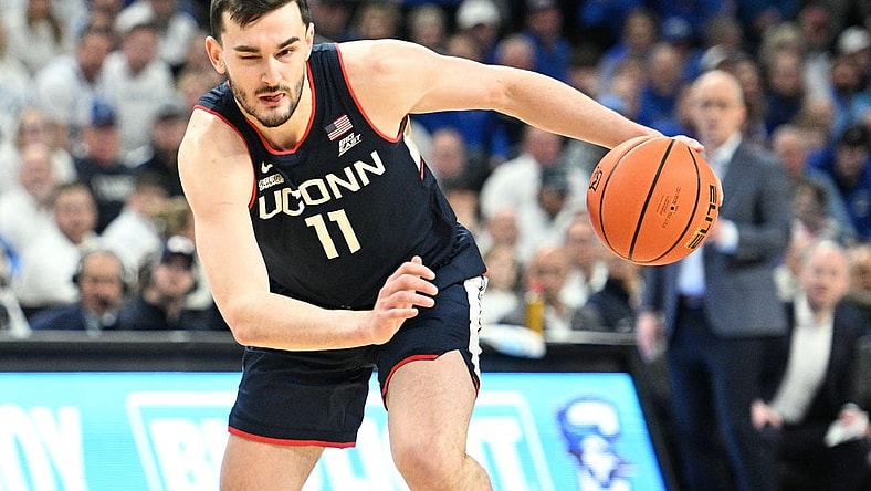 Feb 20, 2024; Omaha, Nebraska, USA;  Connecticut Huskies forward Alex Karaban (11) dribbles against the Creighton Bluejays in the first half at CHI Health Center Omaha. Mandatory Credit: Steven Branscombe-USA TODAY Sports