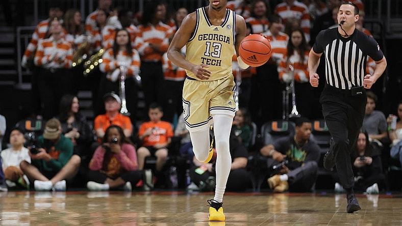 Feb 24, 2024; Coral Gables, Florida, USA; Georgia Tech Yellow Jackets guard Miles Kelly (13) dribbles the basketball against the Miami Hurricanes during the first half at Watsco Center. Mandatory Credit: Sam Navarro-USA TODAY Sports