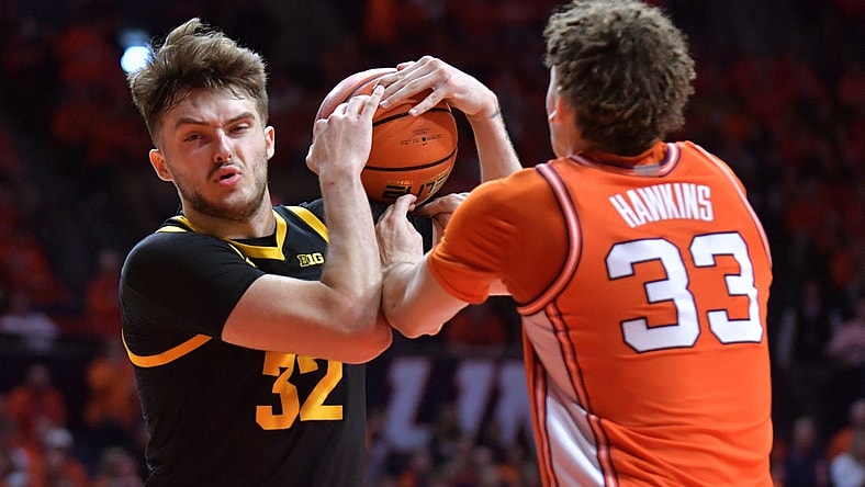 Illinois Fighting Illini forward Coleman Hawkins (33) and Iowa Hawkeyes forward Owen Freeman (32) wrestle for a rebound during the second half at State Farm Center. Mandatory Credit: Ron Johnson-USA TODAY Sports