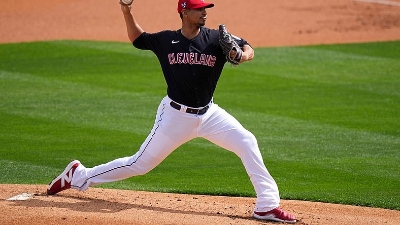 Cleveland Guardians pitcher Carlos Carrasco delivers a pitch in the first inning during a MLB spring training baseball game against the Cincinnati Reds, Saturday, Feb. 24, 2024, at Goodyear Ballpark in Goodyear, Ariz.