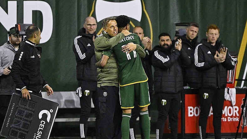 Feb 24, 2024; Portland, Oregon, USA; Portland Timbers head coach Phil Neville hugs forward Antony (11) during the second half against the Colorado Rapids at Providence Park. Mandatory Credit: Troy Wayrynen-USA TODAY Sports