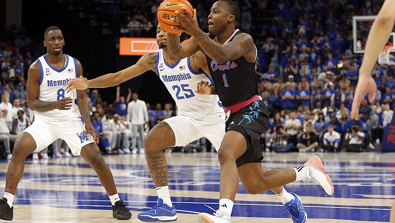 Feb 25, 2024; Memphis, Tennessee, USA; Florida Atlantic Owls guard Johnell Davis (1) drives to the basket as Memphis Tigers guard Jayden Hardaway (25) defends during the second half at FedExForum. Mandatory Credit: Petre Thomas-USA TODAY Sports